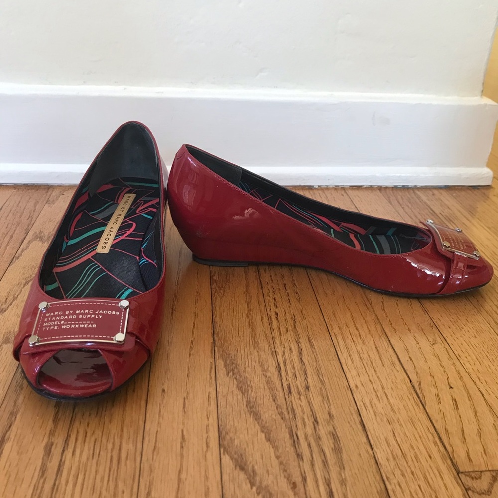 Lightly worn red patent peep toe flats